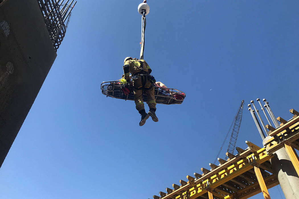 A member of the Clark County Fire Department helps with a rescue of a construction worker Satur ...