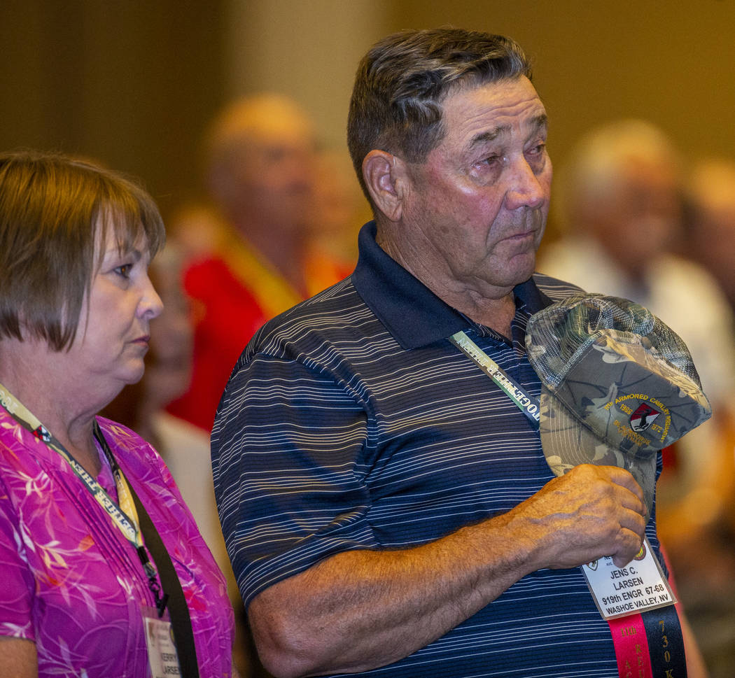 Veteran Jens Larsen, right, and his spouse Kerry stand during a benediction for those who serve ...