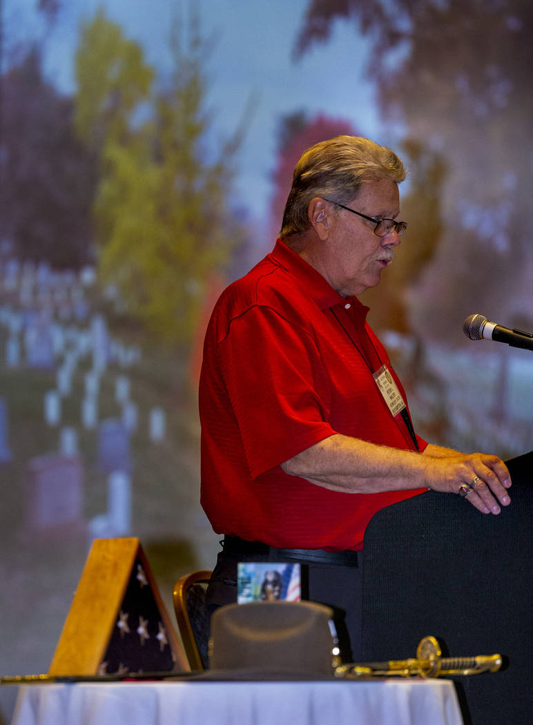 President Peter Walter reads a verse to veterans and spouses who served in Vietnam during a rem ...