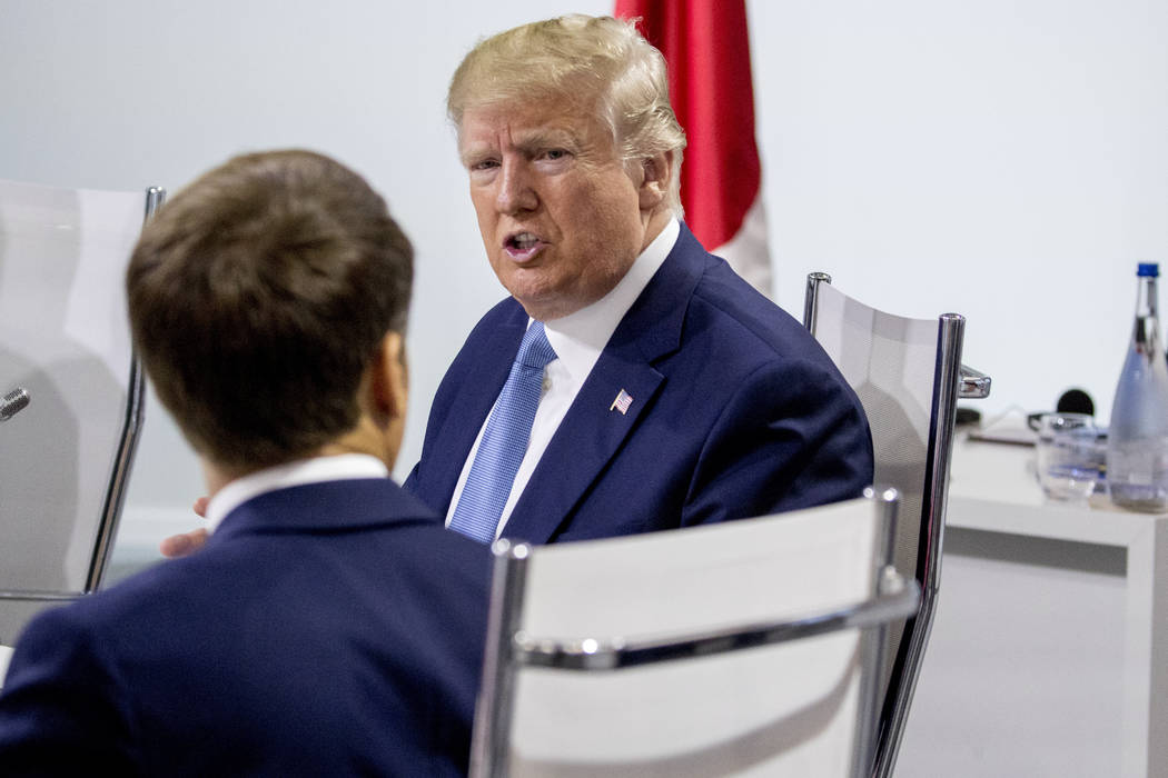 French President Emmanuel Macron, left, and President Donald Trump, right, participate in a G-7 ...