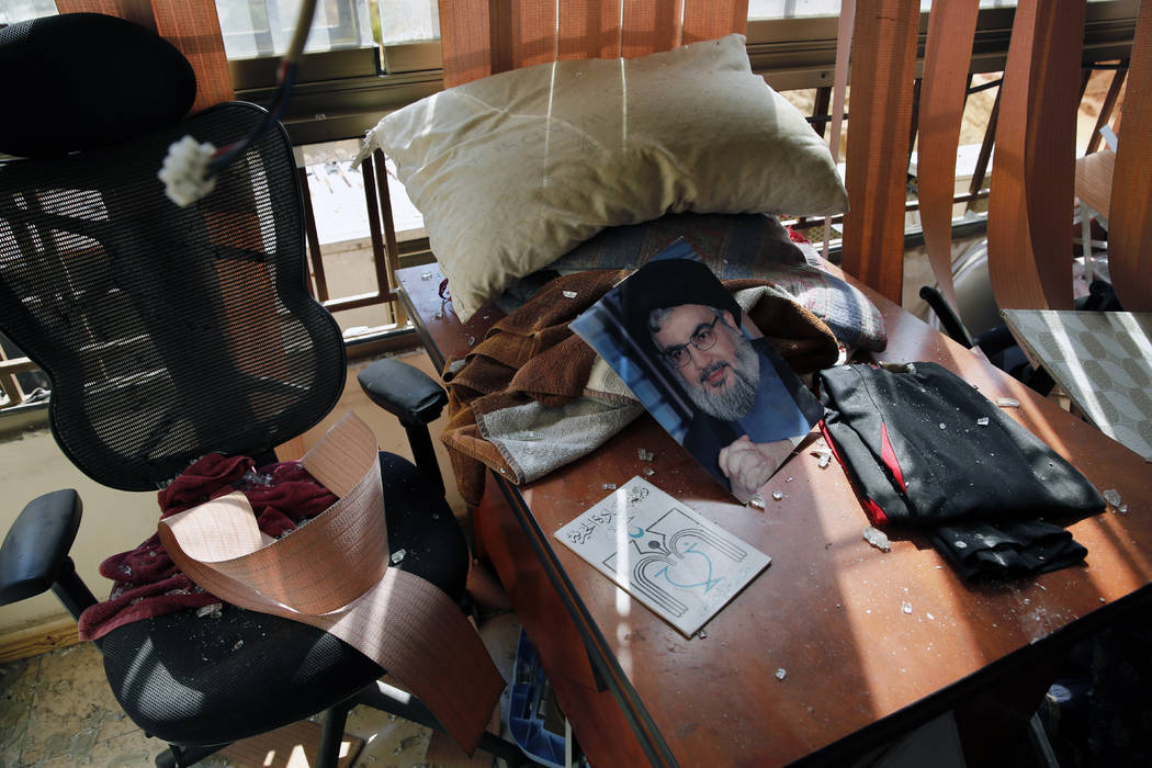 A poster of Hezbollah leader Sayyed Hassan Nasrallah is seen amid other damage inside the media ...