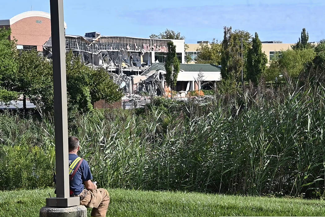 A Howard County emergency responder looks on at the damage caused by a gas explosion at the Lak ...