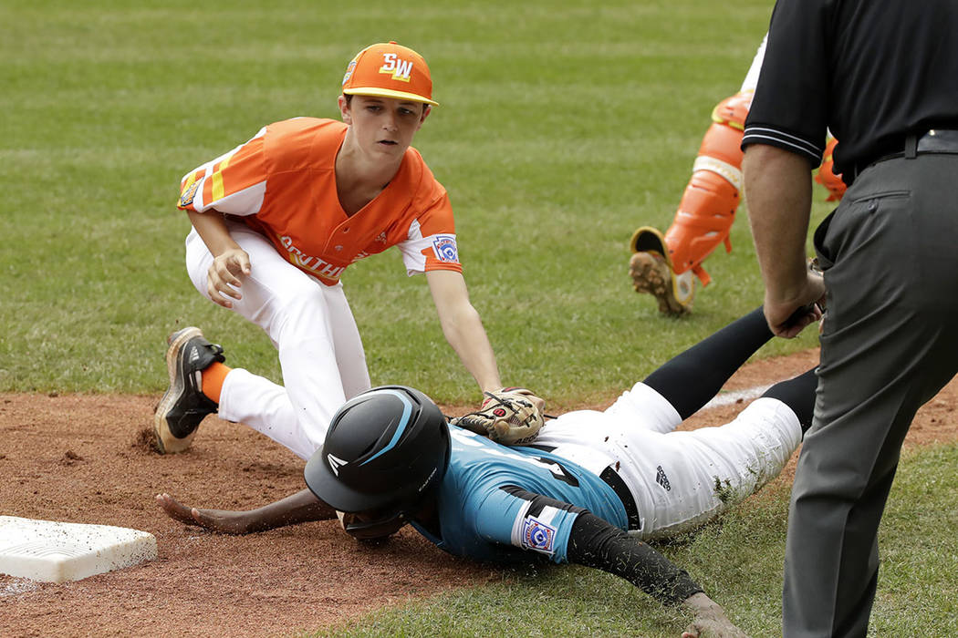 River Ridge, Louisiana's Marshall Louque, top, tags out Curacao's Jurdrick Profar (13) who was ...