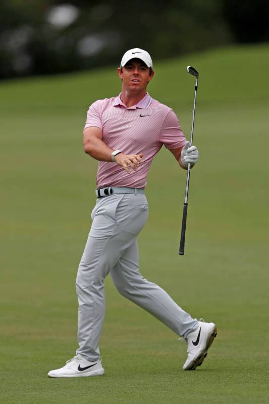 Rory McIlroy reacts as he watches his shot on the second fairway during the final round of the ...