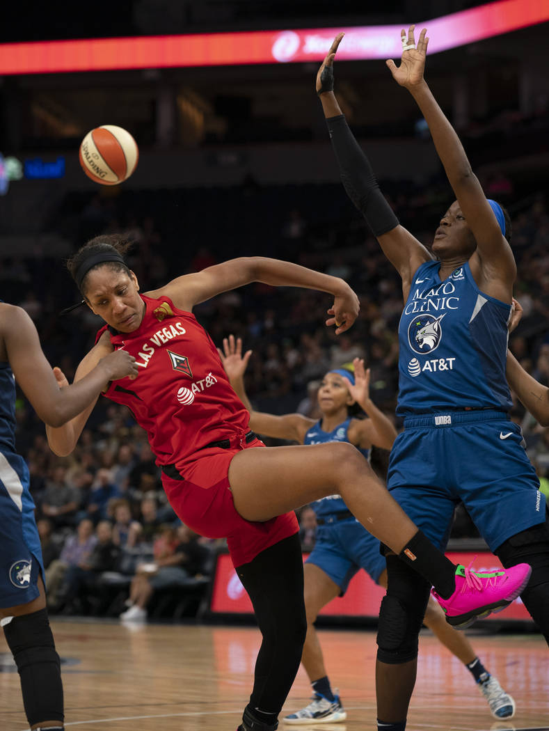 Las Vegas Aces center A'ja Wilson (22) loses her balance and control of the ball while defended ...