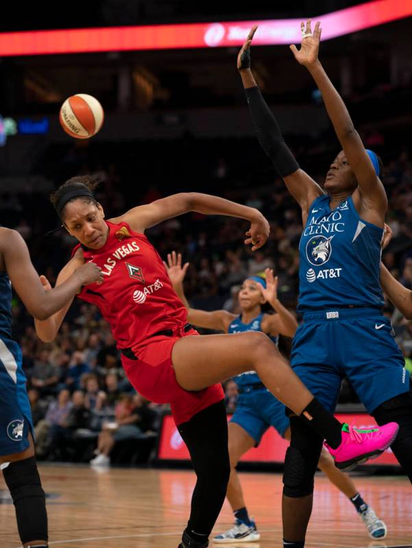 Las Vegas Aces center A'ja Wilson (22) loses her balance and control of the ball while defended ...