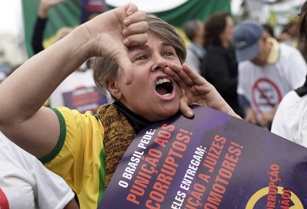 A woman shouts slogans against corruption during a rally in support of the government's "C ...