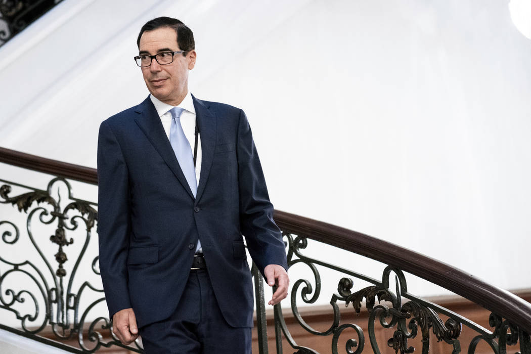 Treasury Secretary Steve Mnuchin walks to a working breakfast with President Donald Trump and B ...