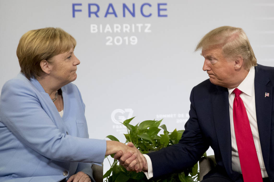 U.S. President Donald Trump and German Chancellor Angela Merkel, left, shake hands during a bil ...