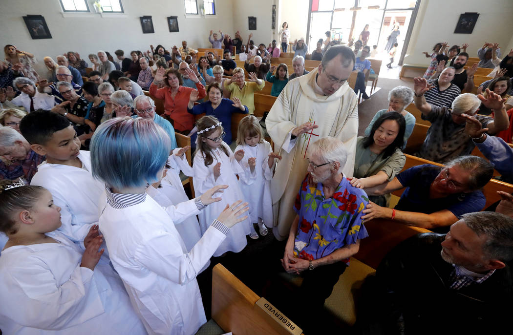 In this May 5, 2019, photo, Robert Fuller, seated center right, receives a blessing and prayer ...