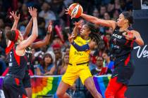 Indiana Fever guard Kelsey Mitchell (0) has a pass deflected by Las Vegas Aces center Liz Camba ...