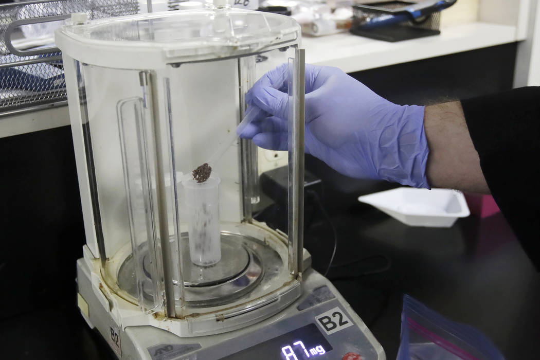 In an Aug. 16, 2019, photo, chemist David Dawson pours pieces of a cannabis-infused chocolate b ...