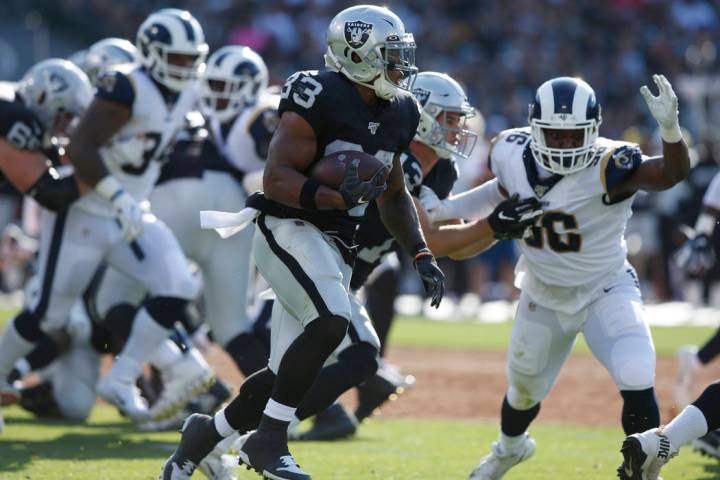 Oakland Raiders' DeAndre Washington (33) runs against the Los Angeles Rams during the first hal ...