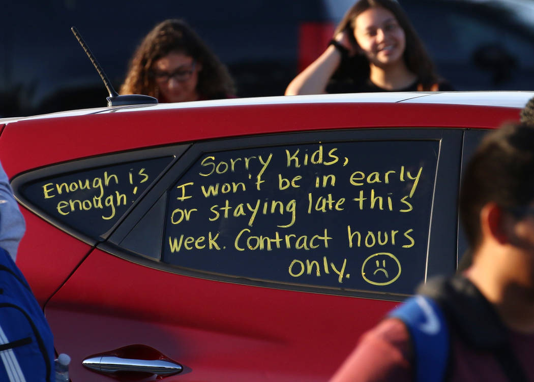 A note "Contract Hours Only'' written on the side windows of a teacher car is seen as teac ...