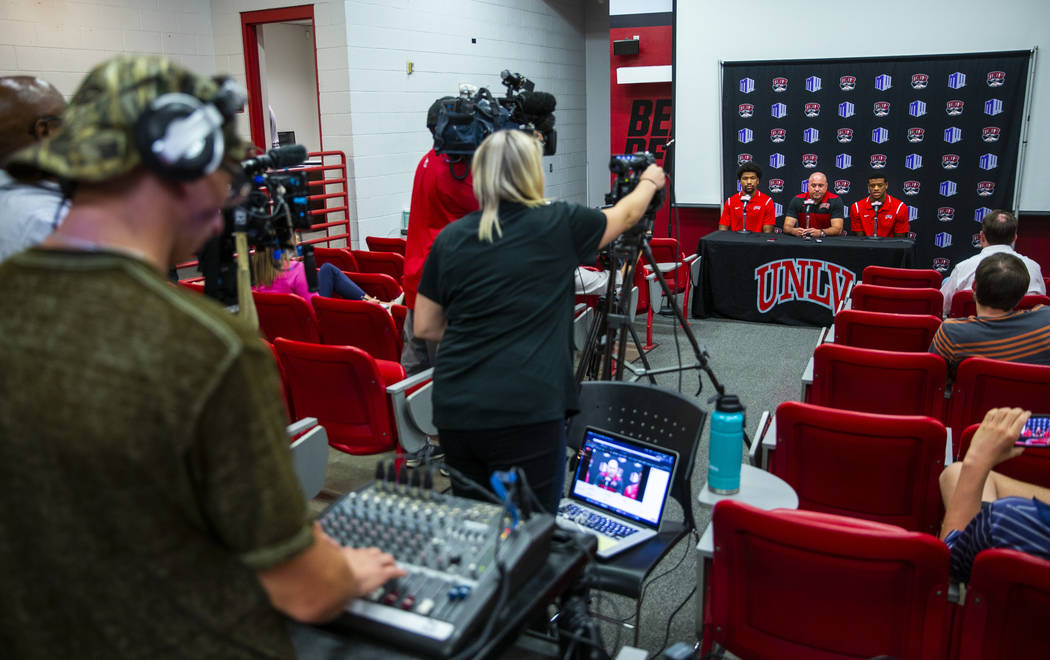 UNLV football quarterback Armani Rogers, head coach Tony Sanchez and linebacker Javin White ans ...