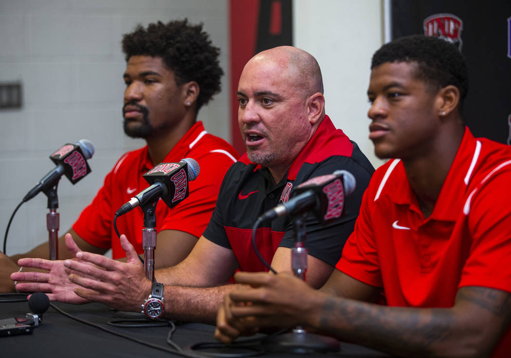 UNLV football head coach Tony Sanchez, center, answers a media question beside quarterback Arma ...