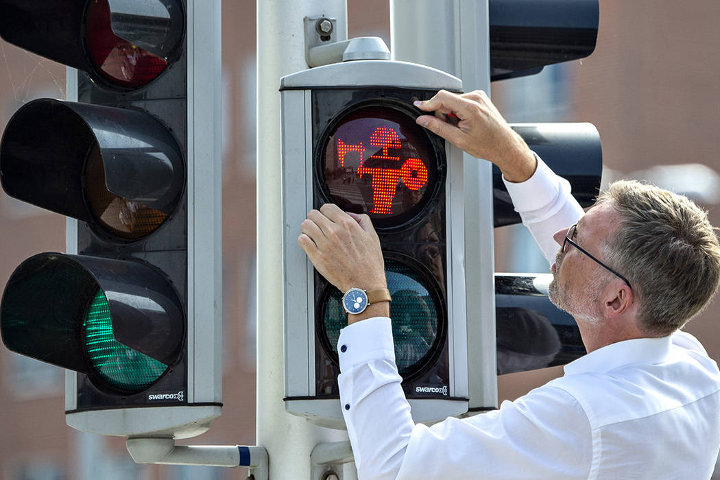 Director of Moesgaard Museum Mads Kähler Holst replaces the first of many pedestrian signa ...