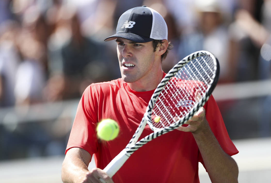 Reilly Opelka, of the US, returns a shot to Fabio Fognini, of Italy, during the first round of ...