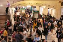 In this Aug. 23, 2019, photo, people pass through New York's Grand Central Terminal. With just ...