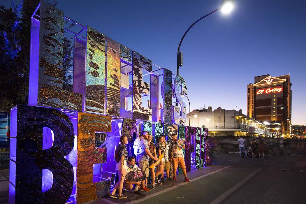 Festivalgoers pose next to a Life is Beautiful sign at the annual festival in downtown Las Vega ...