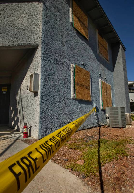 Fire department warning tape blocks the apartment entrance from an early morning fire at The Br ...