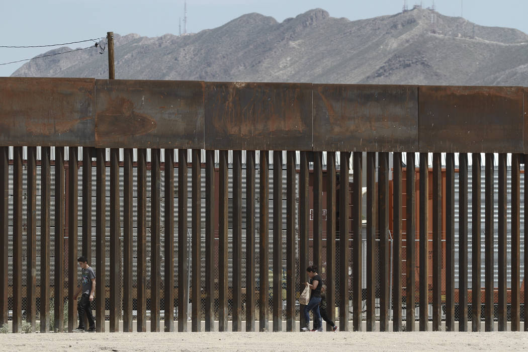 FILE - In this July 17, 2019, file photo, three migrants who had managed to evade the Mexican N ...