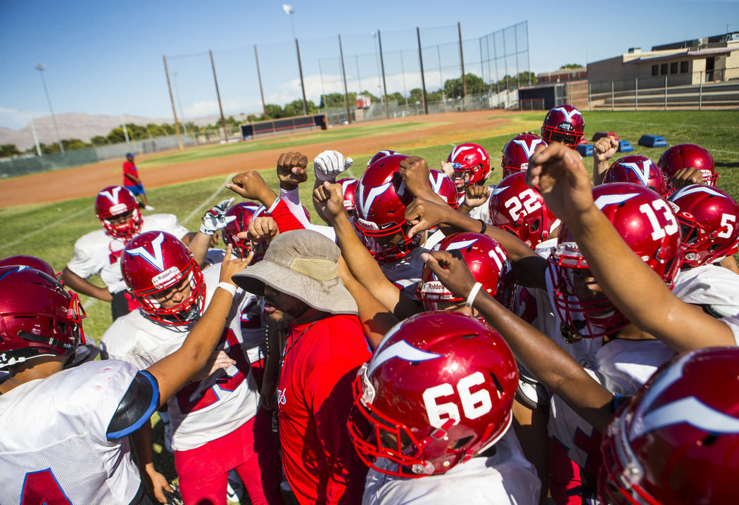 Valley coach Quincy Burts, left, leads football practice at the baseball field at Valley High S ...