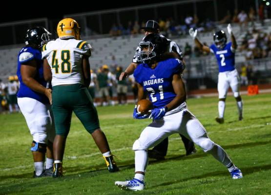 Desert Pines' Julian Lawence (21) scores a touchdown against Bishop Manogue during the second h ...