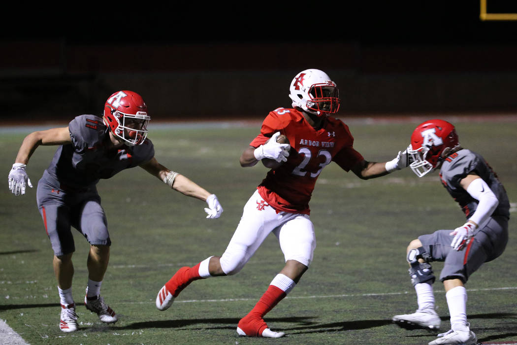 Arbor View's Ziaire Ham (23) returns an interception against American Fork's Tanner Holden (11) ...