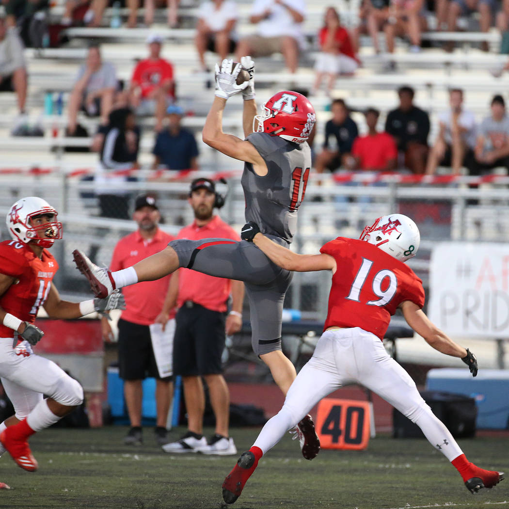 American Fork's Tanner Holden (11) makes a catch under pressure from Arbor View's Devin Ramirez ...