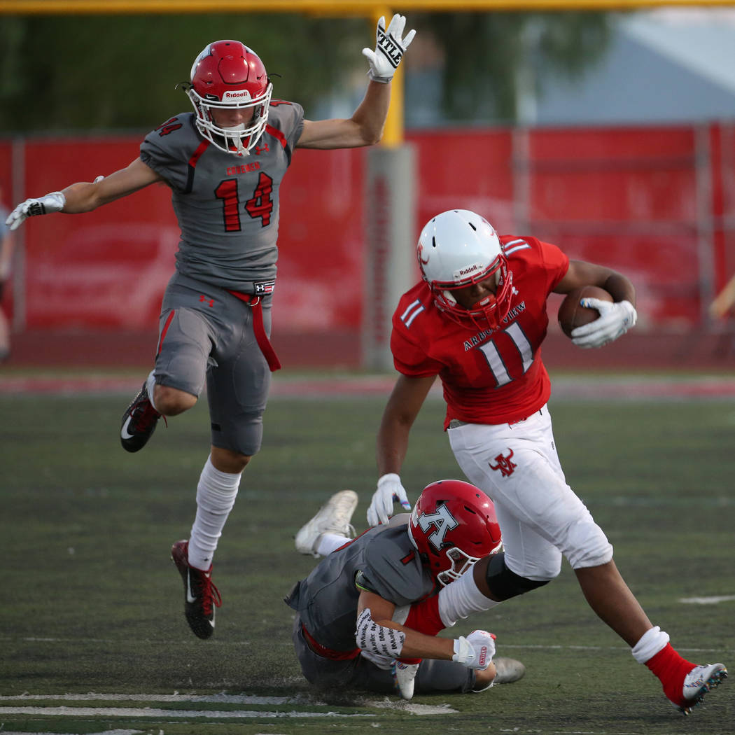Arbor View's Jaedyn Jackson (11) runs the ball under pressure from American Fork's Fisher Inger ...
