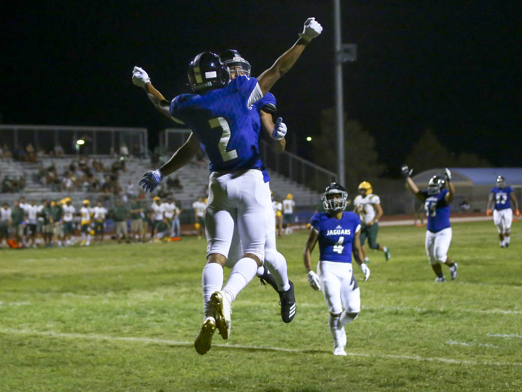 Desert Pines' Deandre Moore (2) celebrates his interception with Michael Jackson lll during the ...