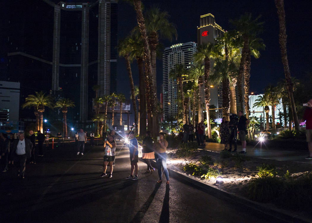 People watch as the "Sam by Starck" statue at the SLS Las Vegas is demolished ahead o ...