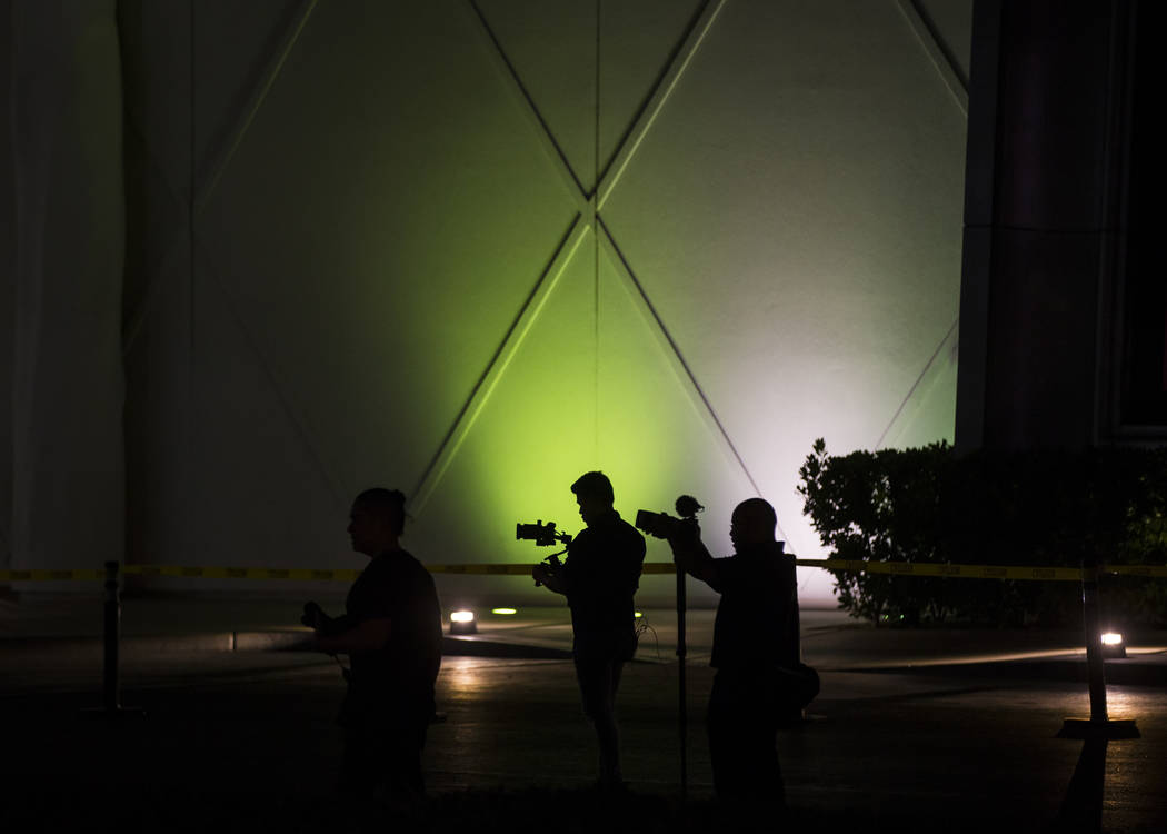 People record the "Sam by Starck" statue at the SLS Las Vegas moments before it's rem ...