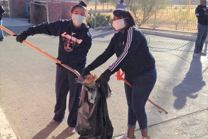 Two members of Top Teens of America volunteer during a Top Ladies of Distinction community serv ...