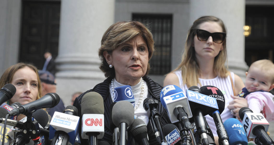 Attorney Gloria Allred, center, flanked by two of her clients, speaks during a news conference ...