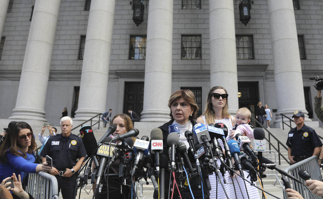 Attorney Gloria Allred, center, flanked by two of her clients, speak during a news conference a ...