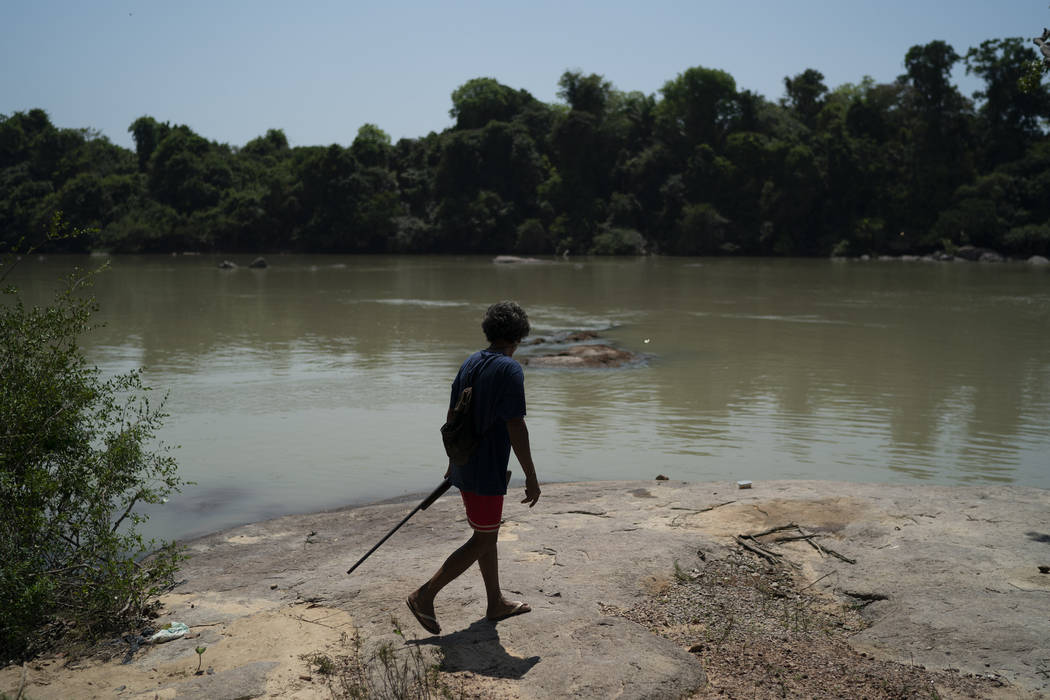 Wakonkra Kayapo, of the Kayapo indigenous community, carries his rifle as he searches for track ...