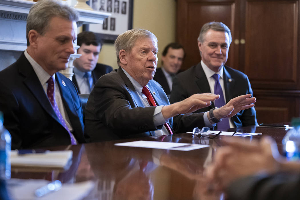 FILE - In this Feb. 14, 2019 file photo, Sen. Johnny Isakson, R-Ga., flanked by Rep. Buddy Cart ...