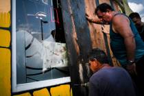 Men board up a shop's windows ahead of the arrival of Hurricane Dorian in Boqueron, Puerto Rico ...