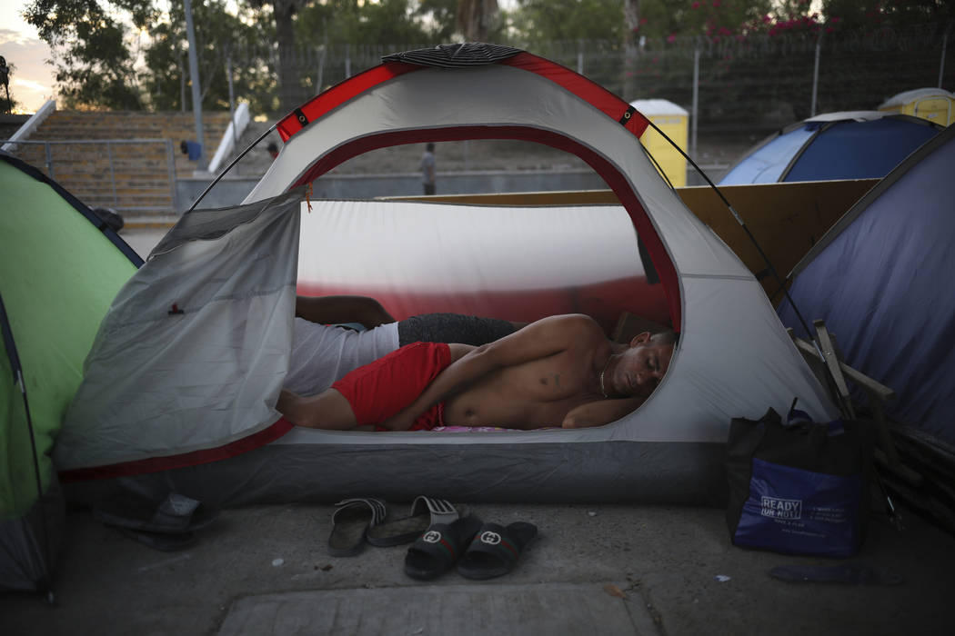 FILE - In this Aug. 4, 2019, file photo, a Cuban migrant sleeps inside a tent at the foot of th ...