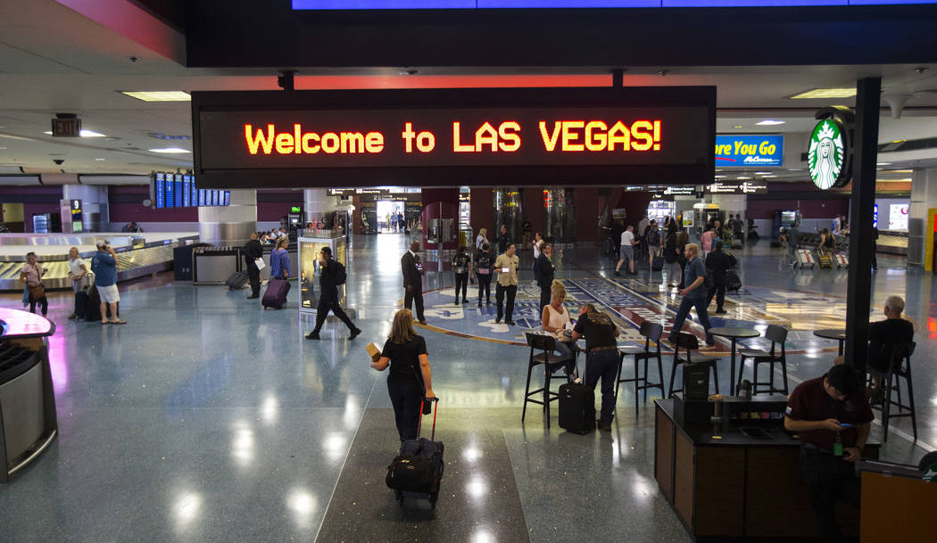 Passengers arrive at McCarran International Airport ahead of the Labor Day holiday weekend in L ...