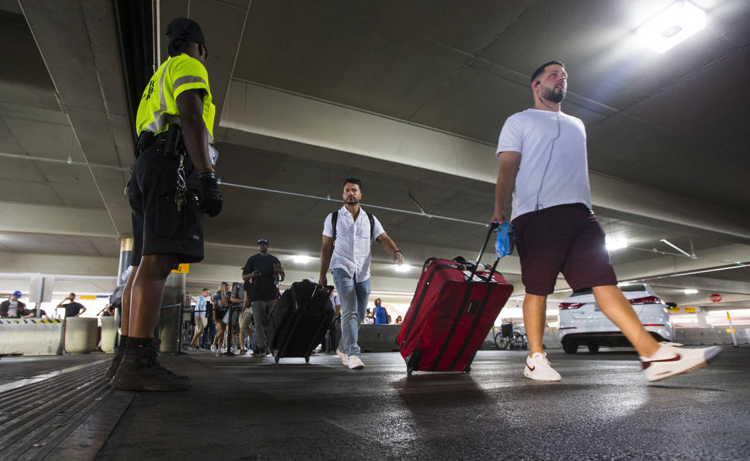 Passengers using rideshare services walk to their respective vehicles after arriving at McCarra ...