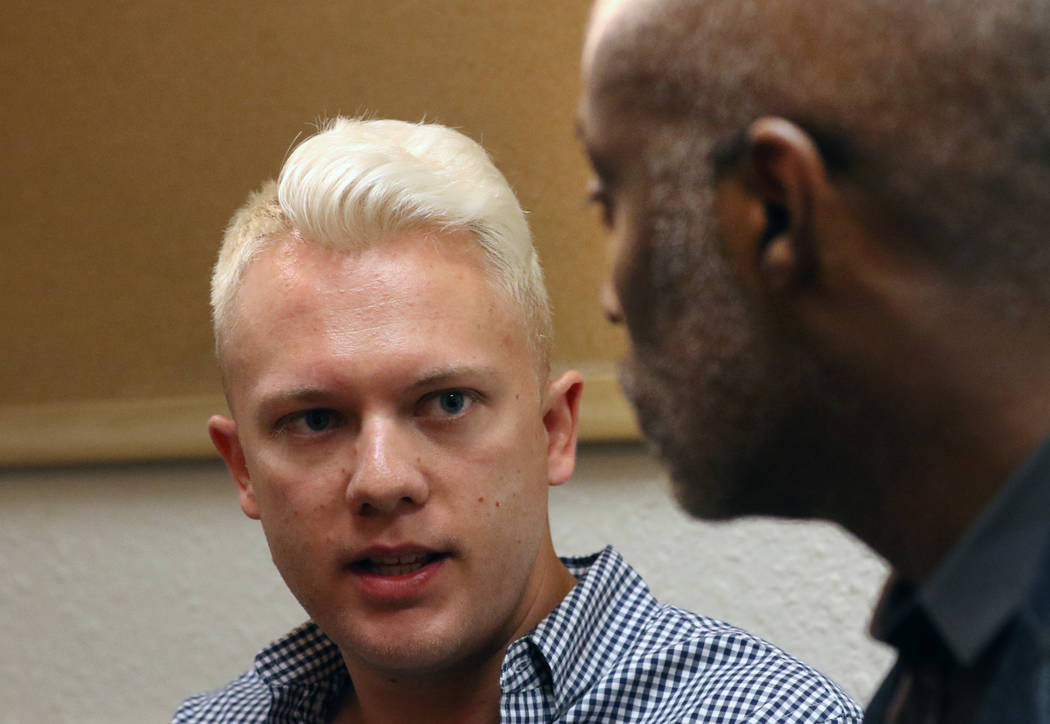 State Director of Silver State Equality, André Wade, right listens as Sam Garrett-Pate of ...