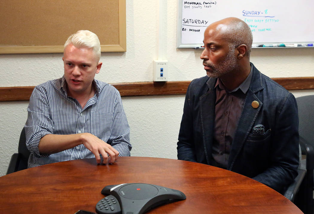 State Director of Silver State Equality, André Wade, right listens as Sam Garrett-Pate of ...