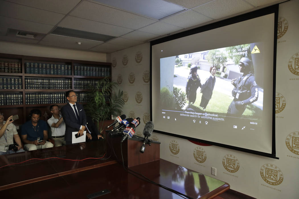 Dr. Henry Lee, left, a forensic scientist, watches a body cam video Wednesday, Aug. 28, 2019, i ...