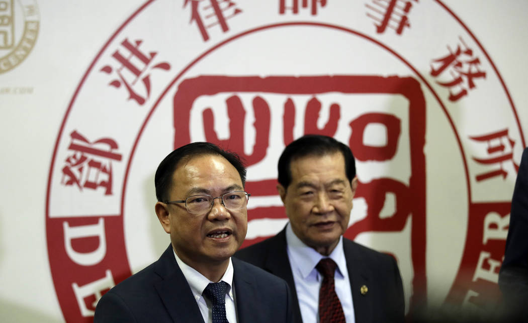 From left, attorney Daniel Deng and forensic scientist Henry Lee hold a joint news conference r ...