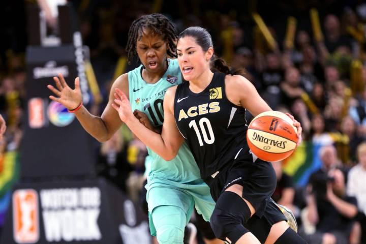 Las Vegas Aces guard Kelsey Plum (10) drives past New York Liberty guard Epiphanny Prince (10) ...