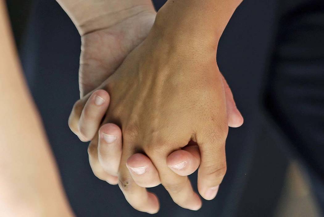 A July 15, 2015, file photo, a lesbian couple holding hands in Salt Lake City. Released on Thur ...