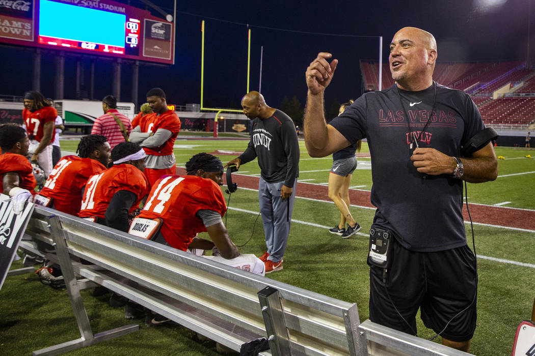 Head coach Tony Sanchez chats with fans in the stands during the UNLV football team scrimmage a ...